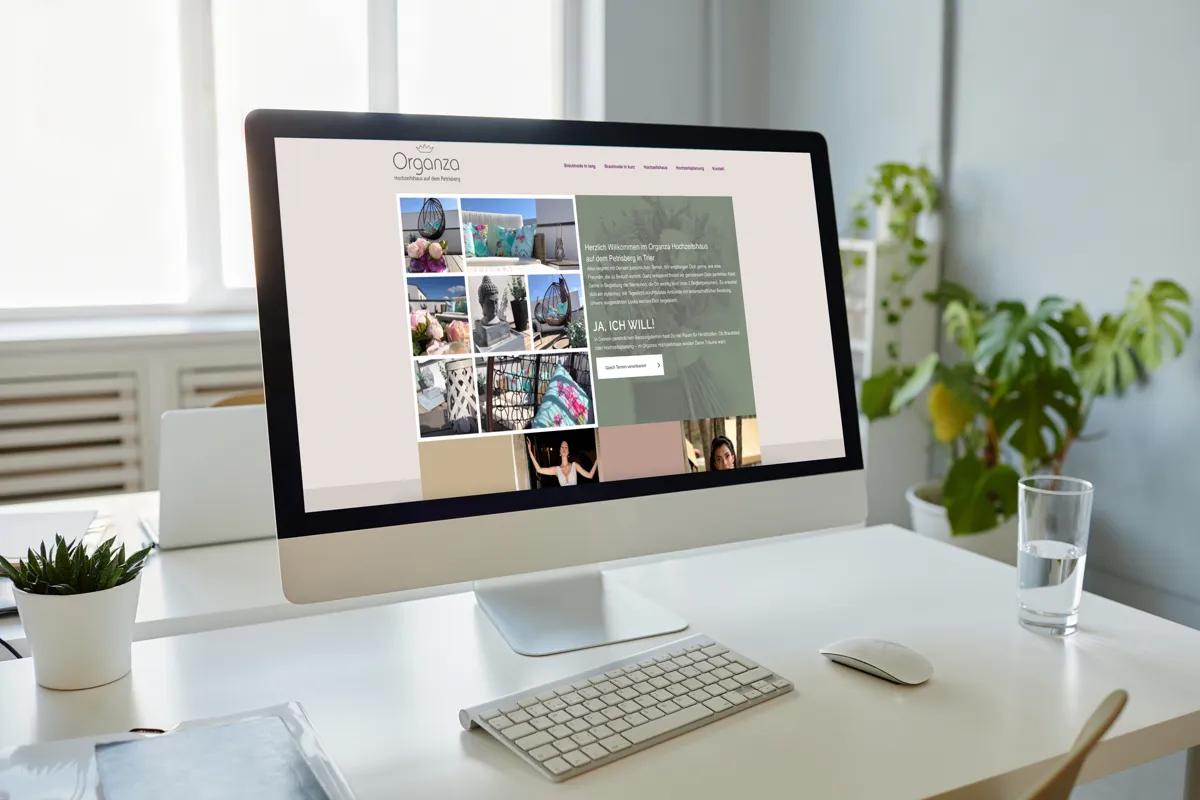 Website des ORGANZA Hochzeitshauses Trier mit Bildergalerie auf einem iMac